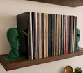 Dark green Division Bell inspired 3D printed vinyl record bookends on a wooden shelf.