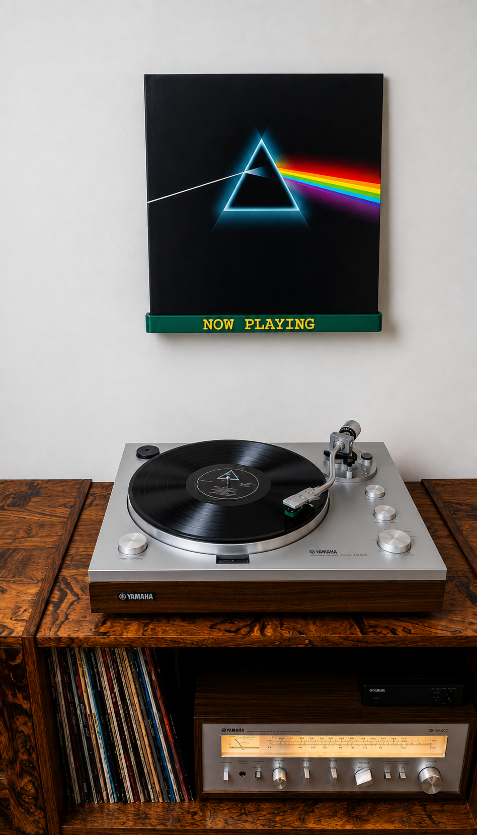Dark green wall-mounted vinyl record shelf with yellow 'NOW PLAYING' text.