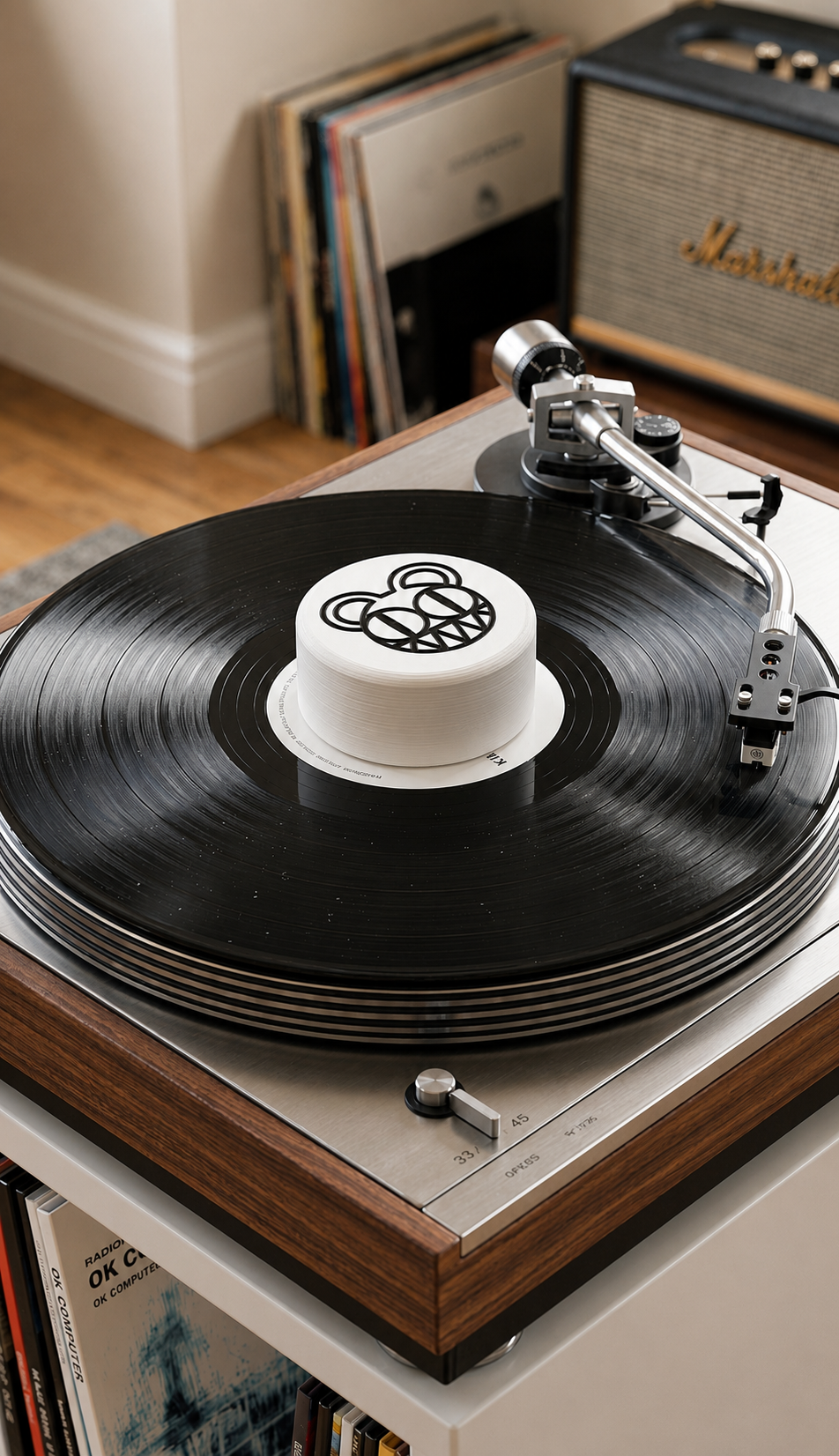White record stabilizer with black bear graphic on a turntable.