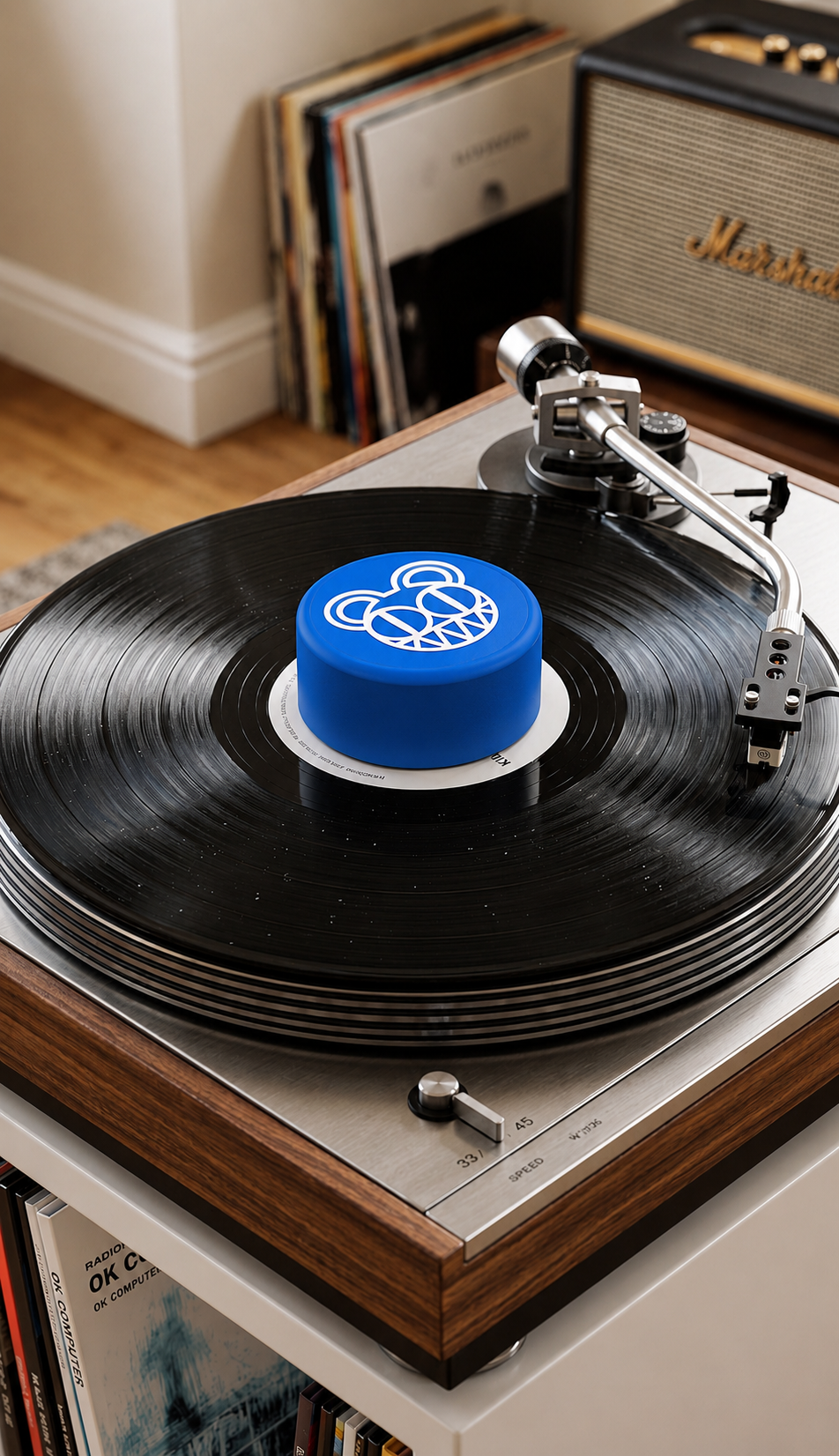Blue record stabilizer with white bear graphic on a turntable.