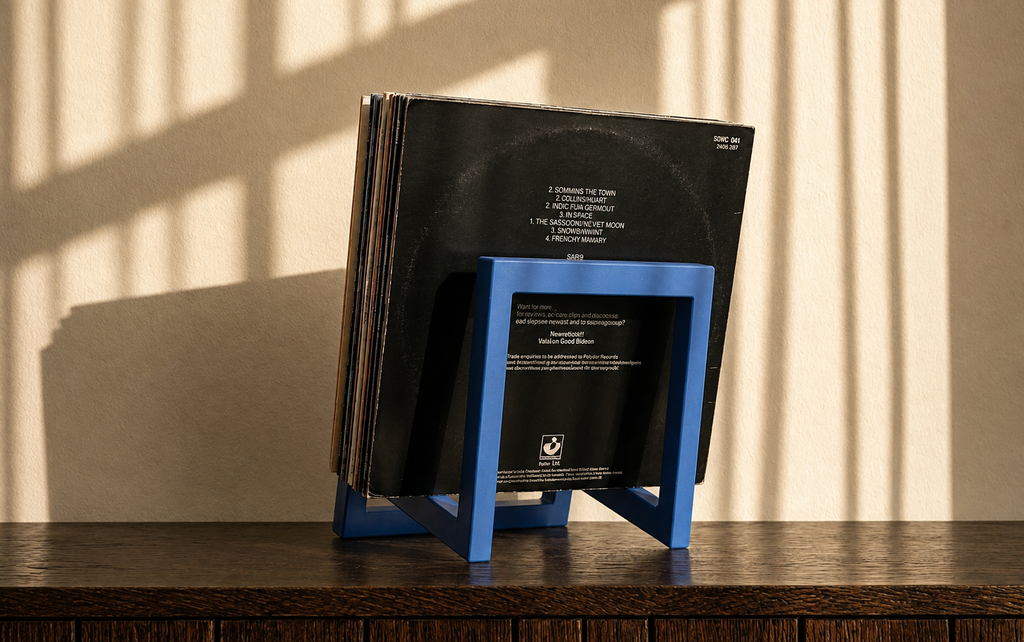 Blue square-frame vinyl record stand, back view, holding a stack of records.