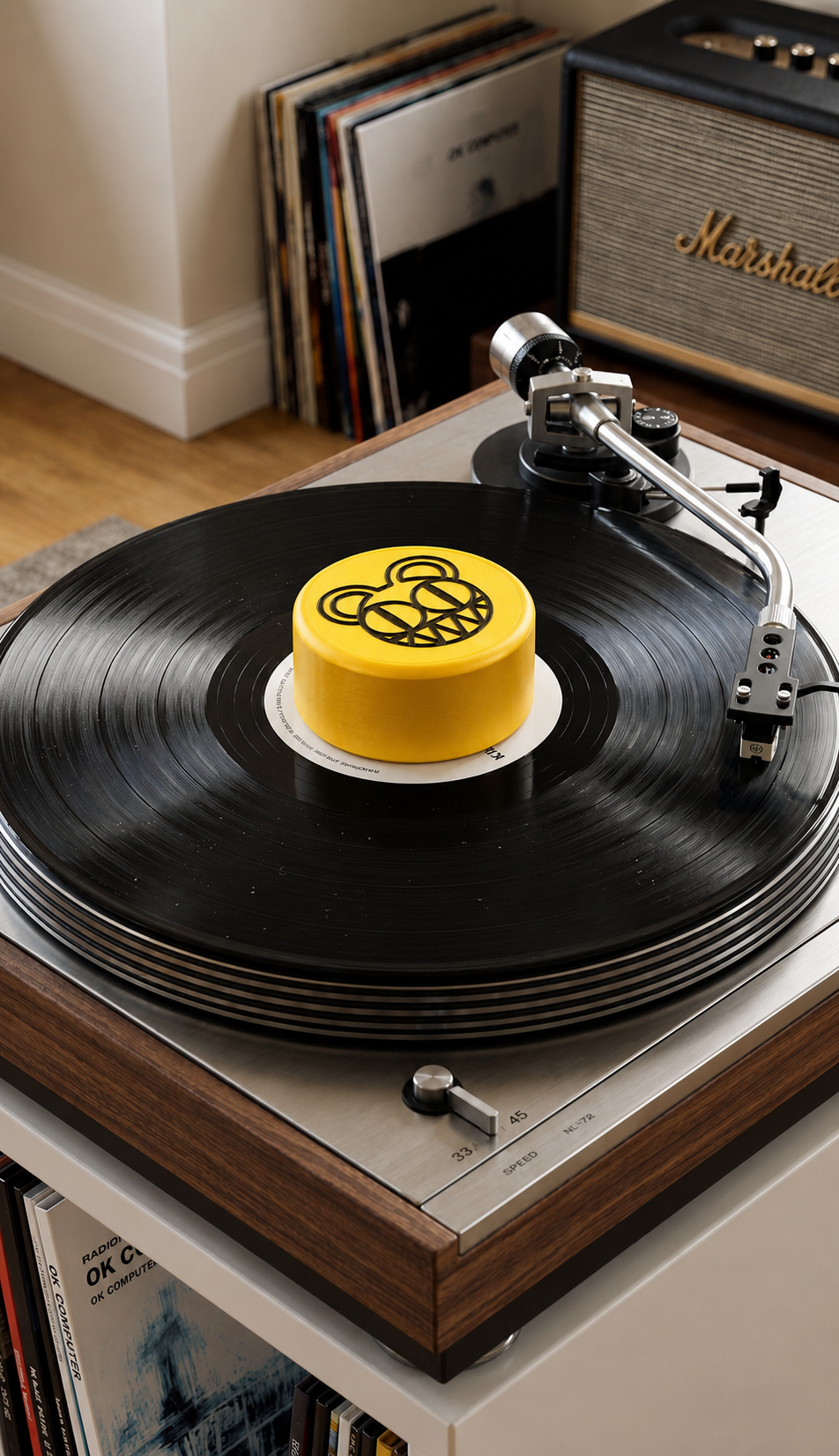 Yellow record stabilizer with black bear graphic on a turntable.