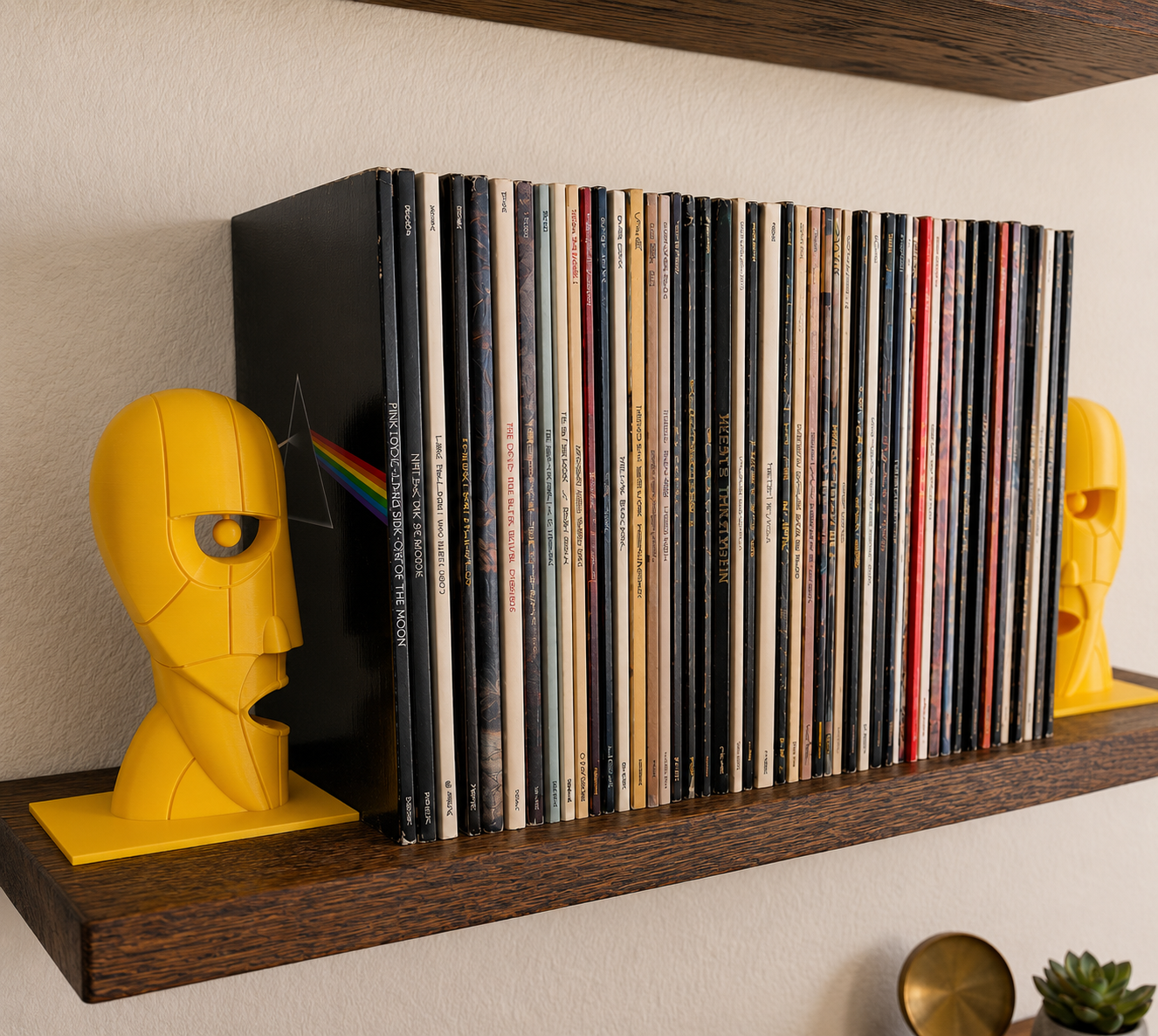 Yellow Division Bell inspired 3D printed vinyl record bookends on a wooden shelf.
